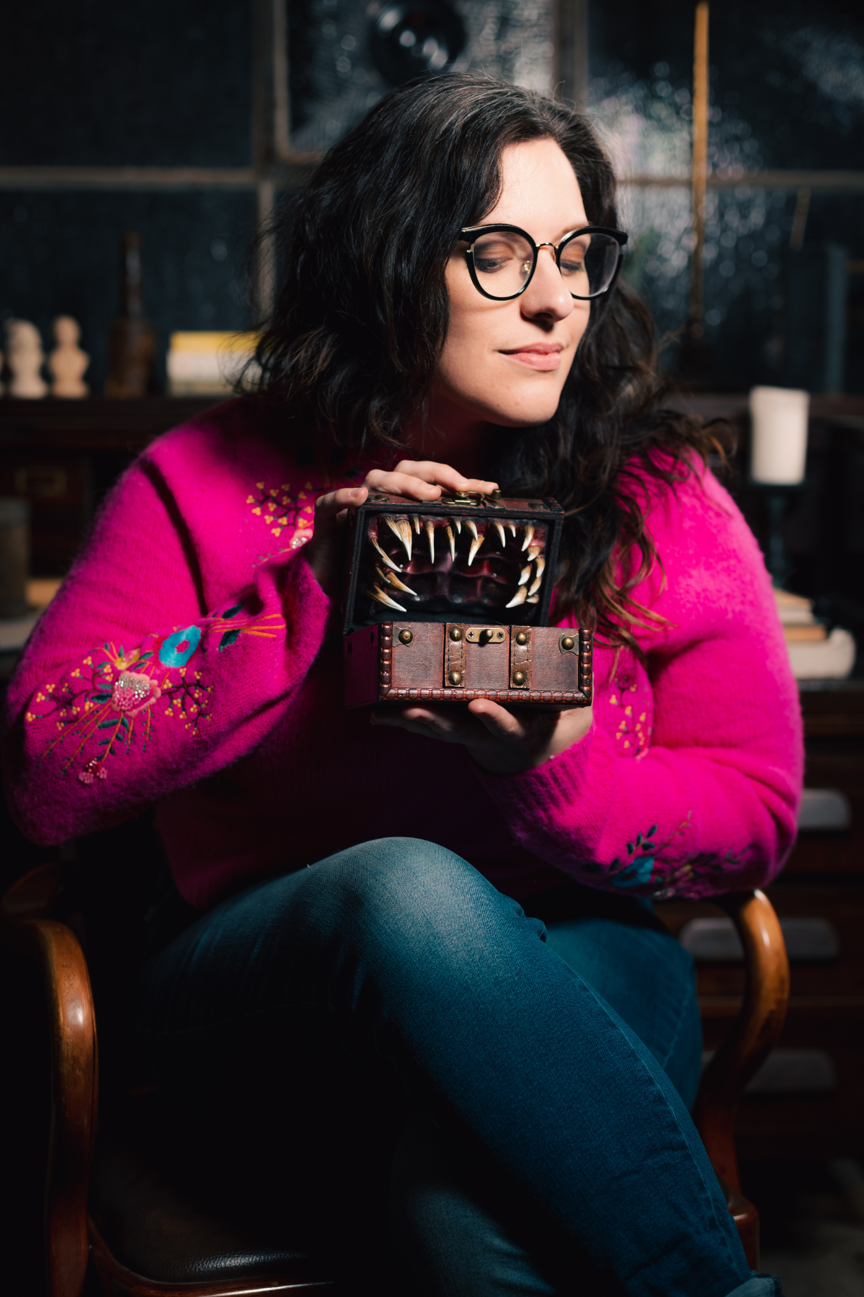 Cate Osborne, a TikToker, podcaster, and sex educator holds a mimic chest from Dungeons and Dragons.